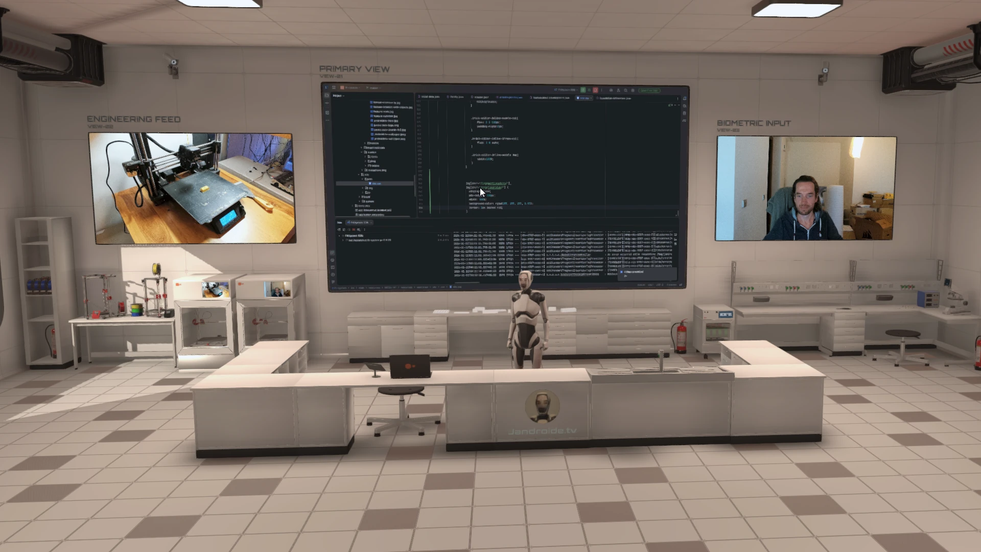 Wide shot of the broadcast studio showing real hardware, screens and a calm working environment.