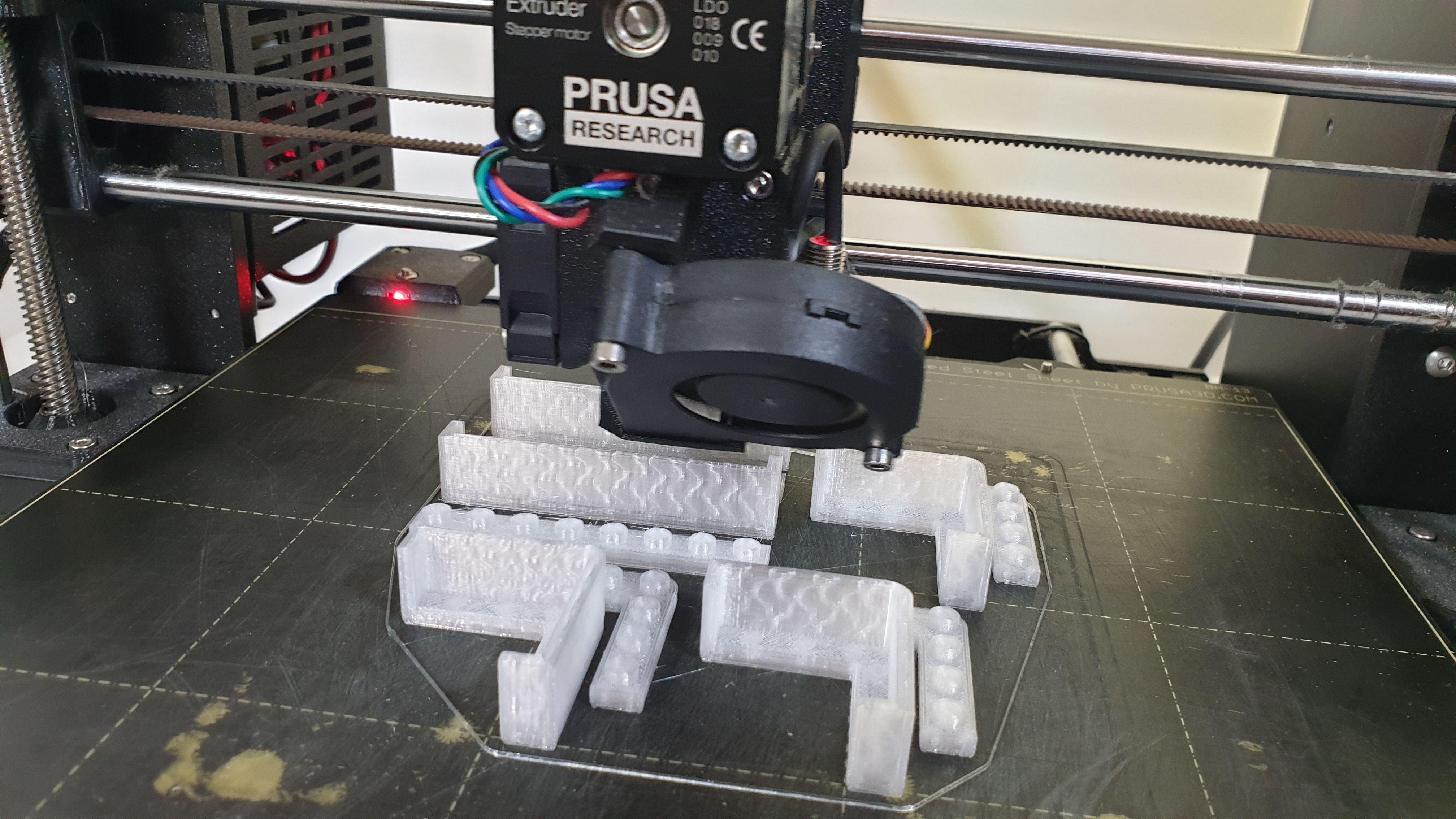 Real printed MachineBlocks arranged on a standardized grid, showing compatibility with existing modular construction systems.