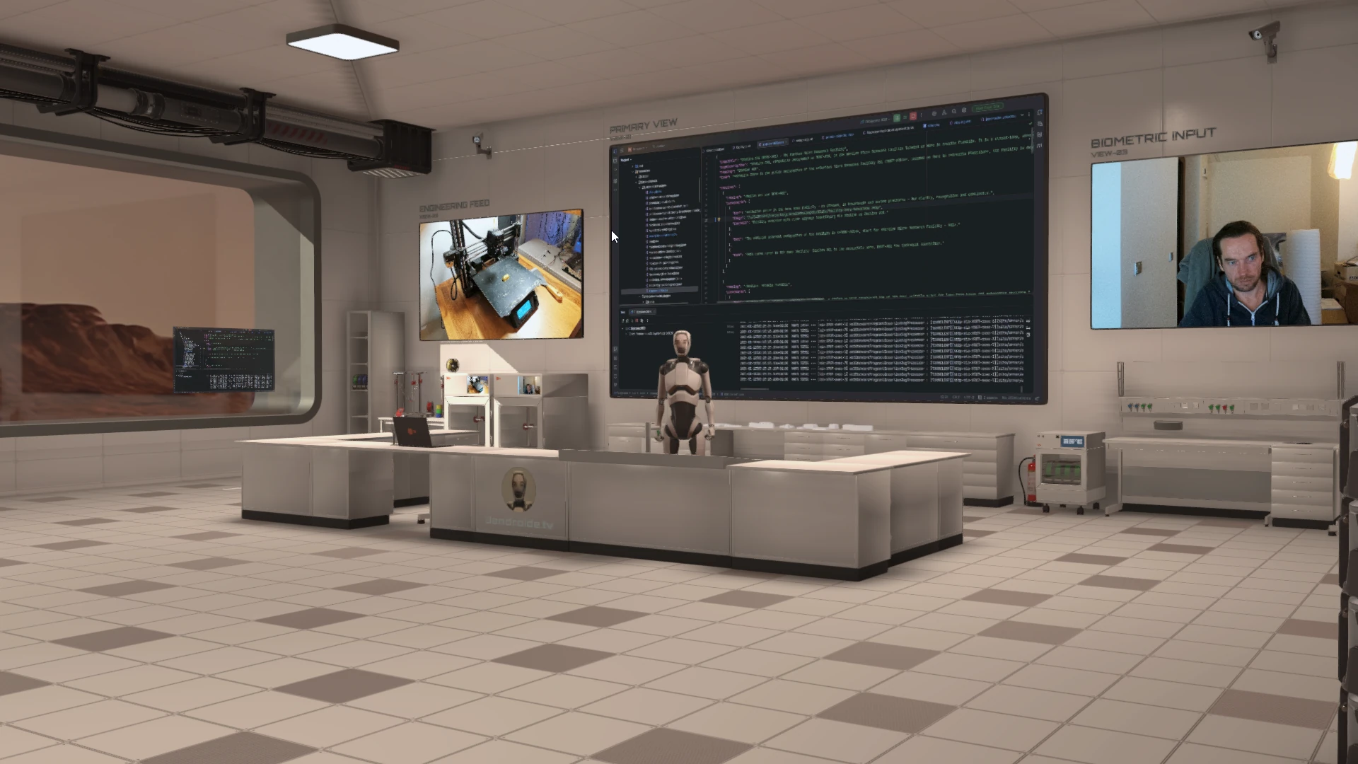 Wide view of the broadcast studio showing screens, lighting and a calm, controlled environment.